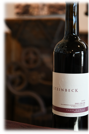 The Crash red blend bottle beside the old press